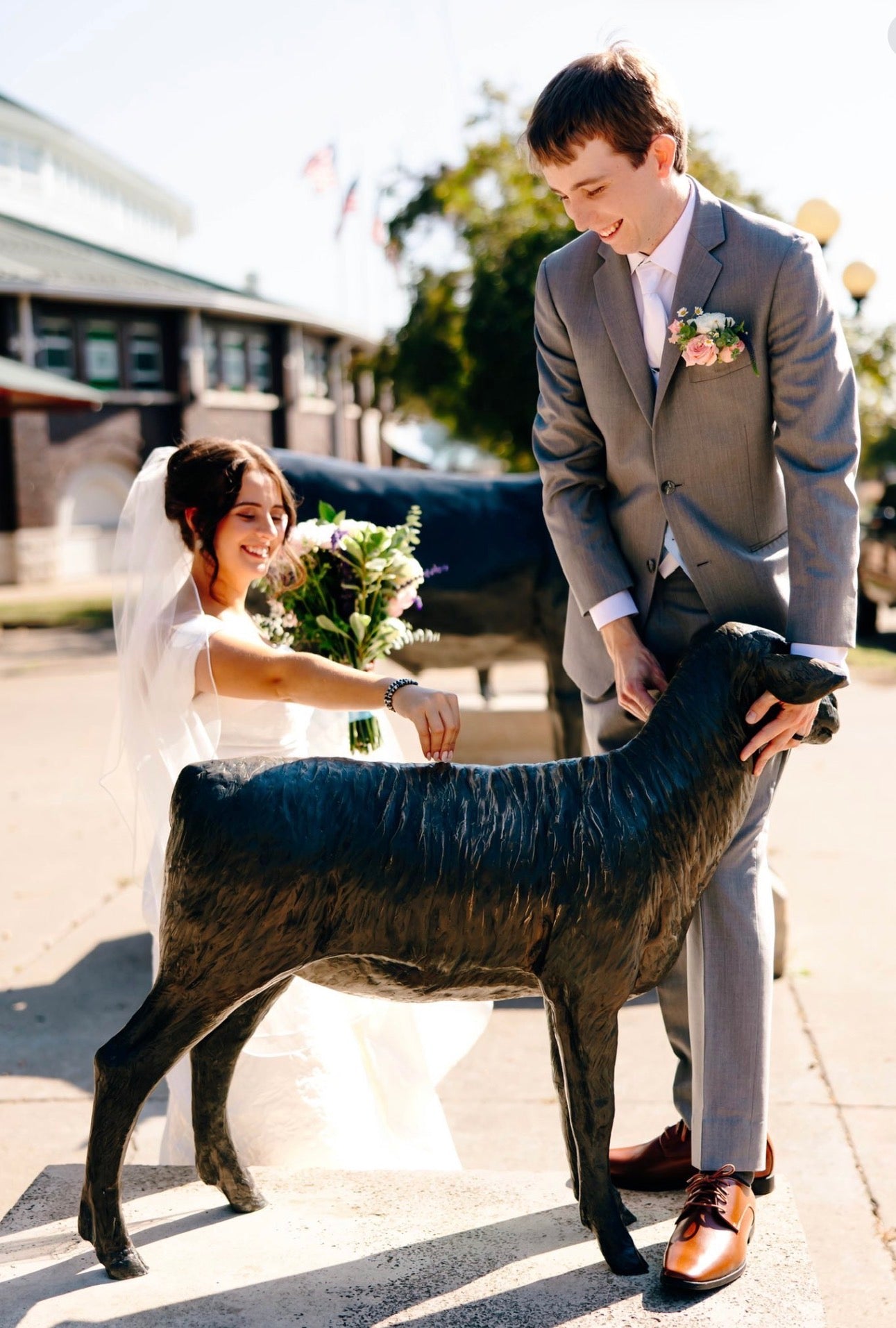 Addie Pretending to show a sheep statue in her wedding dress